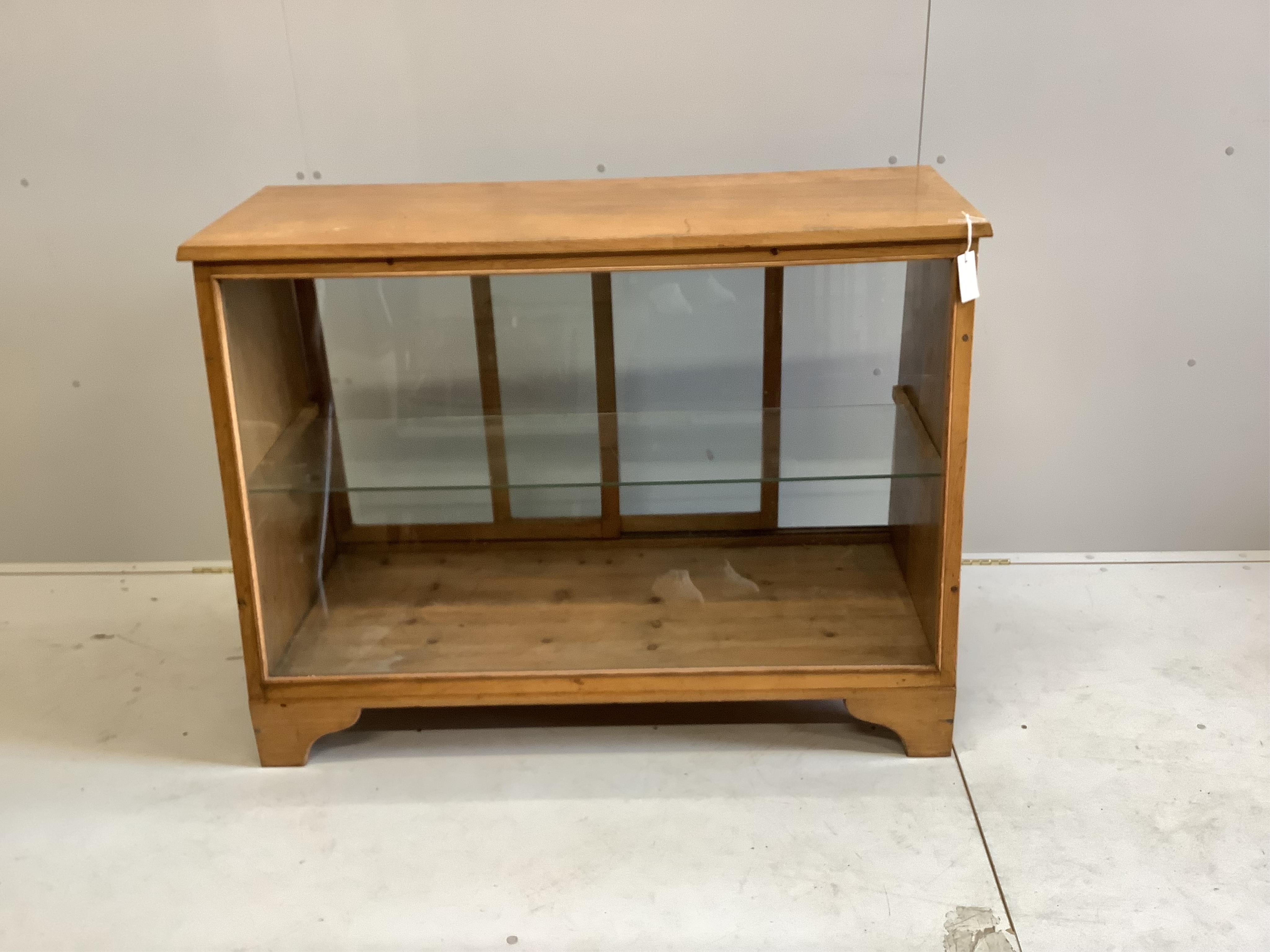 A mid century glazed oak haberdasher's cabinet, width 124cm, depth 56cm, height 90cm. Condition - fair